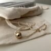IMG_2003.HEIC Asymmetric Double-Strand Seed Pearl Bracelet with Gold Orb in 18K Gold‑Plated Sterling Silver